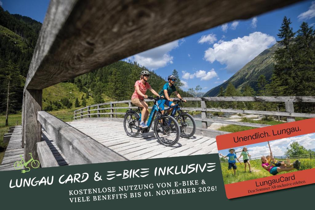 two people are riding bikes on a bridge at Schlossmeierhaus - Kristall Lungau in Mauterndorf