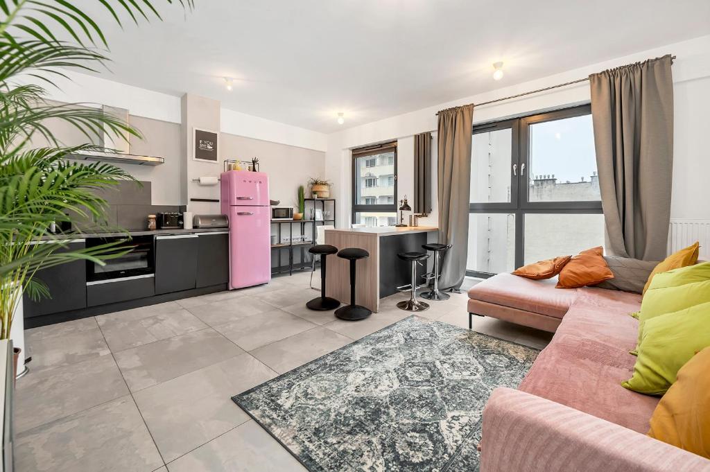 a living room with a pink refrigerator and a kitchen at Lumina I 3BR Apartment with Balcony I Parking I 2 Bathrooms I near Center in Warsaw