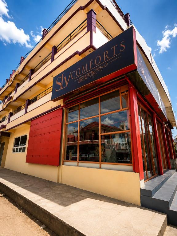 a store front of a building with a sign on it at SLV Comforts in Chikmagalūr