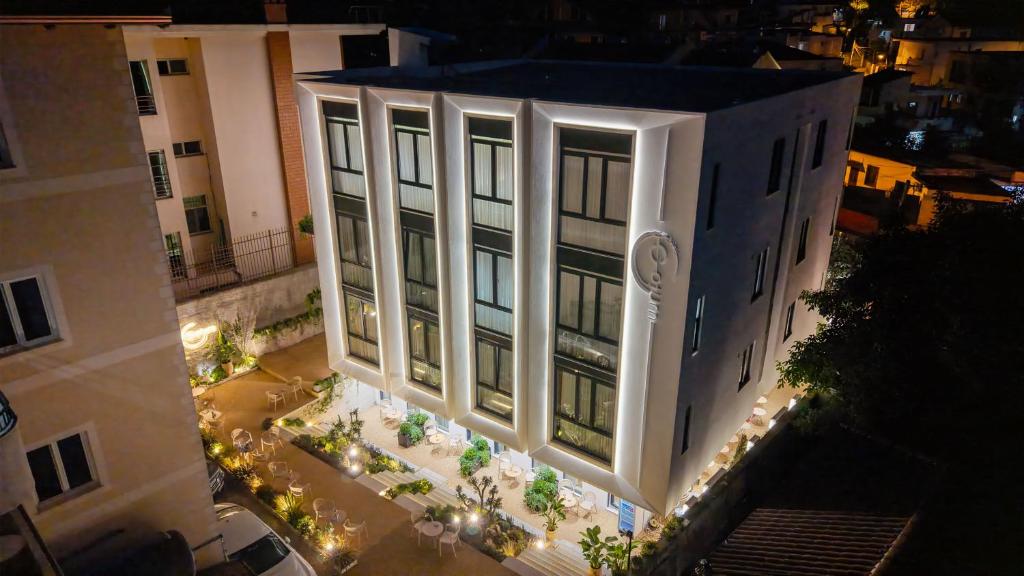 an overhead view of a building at night with lights at Saturn ApartHotel Tirana in Tirana