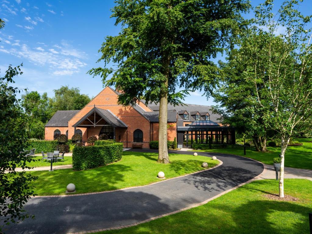 a house with a driveway leading to a building at Clandeboye Lodge Hotel in Bangor