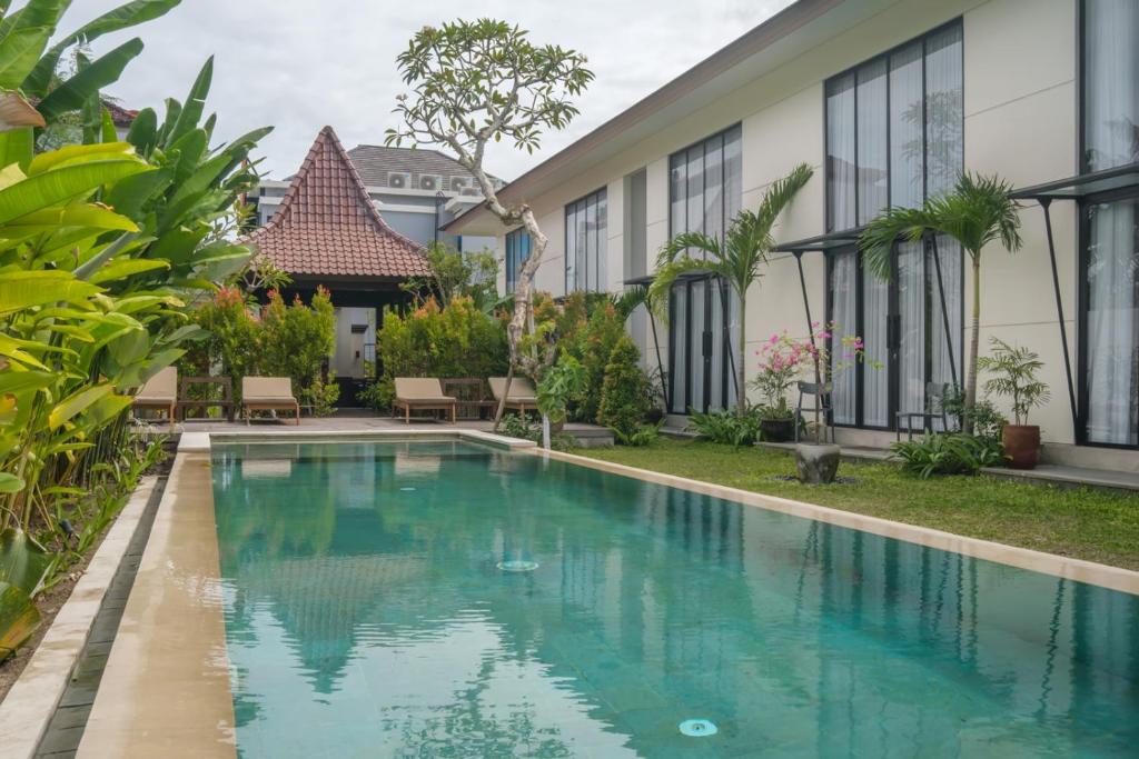 an image of a swimming pool in front of a house at Sunset Loft Seminyak, Bali in Seminyak