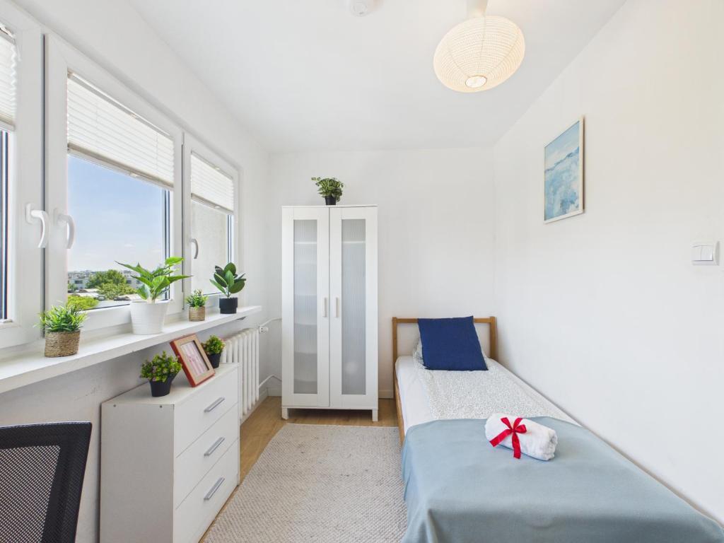 a bedroom with two beds and a window at Comfort ROOM, Kochanowskiego 32 in Warsaw