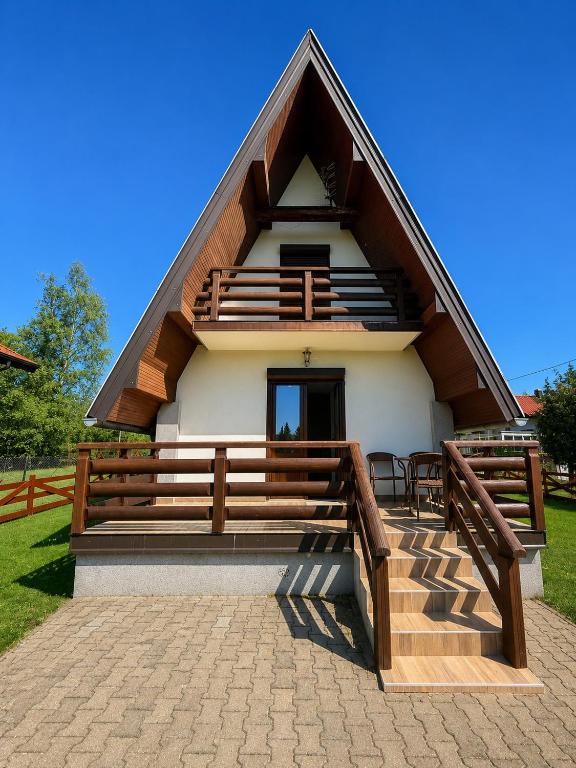 a small house with a gambrel roof with a staircase at Zlatibor week house in Palisat