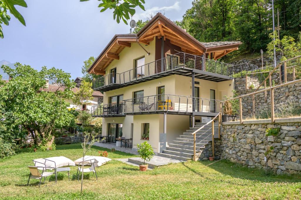 an exterior view of a house with a stone wall at "Lomà" - Aosta Valley EcoResort in Champdepraz