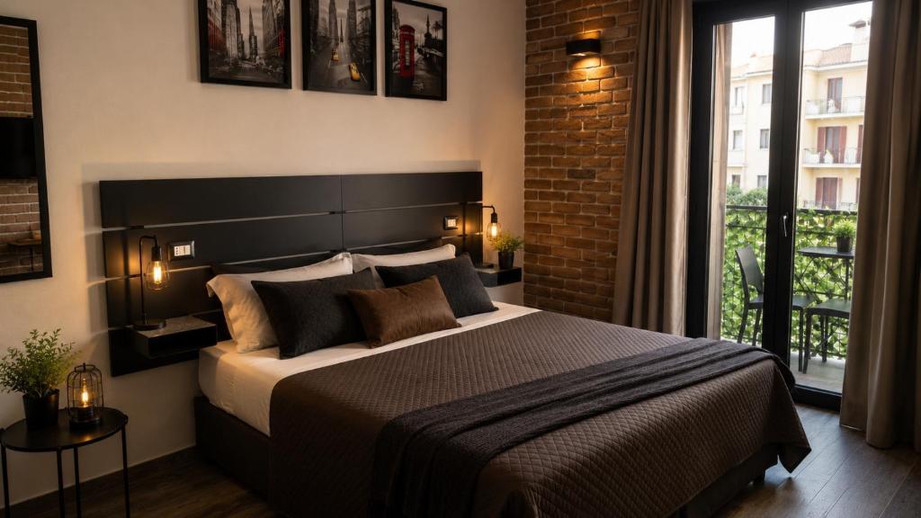 a bedroom with a large bed and a brick wall at LoFT in Bosa