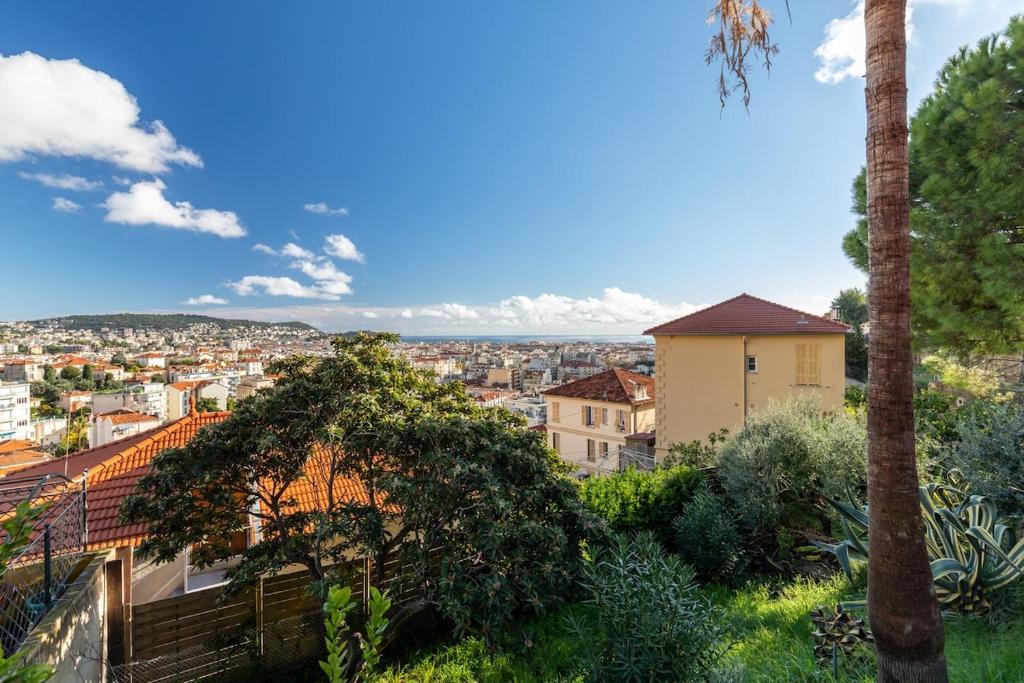 a view of a city from a hill with trees at Villa sur les hauteurs de Nice, proche centre in Nice