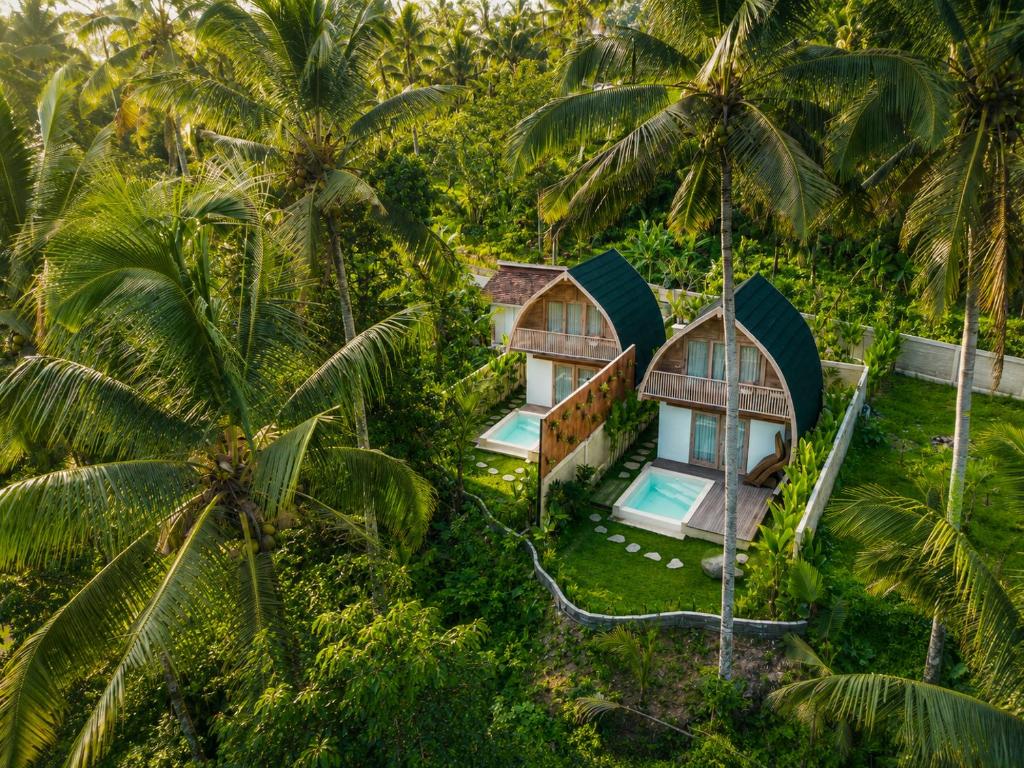 an aerial view of a resort in the jungle with palm trees at Misane Serenity in Gianyar