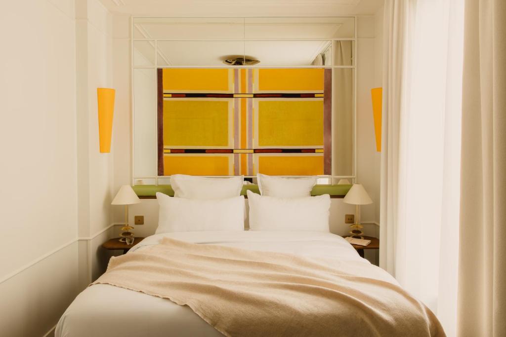 a bedroom with a large bed with white pillows at Hôtel Blanca - Orso Hotels in Paris