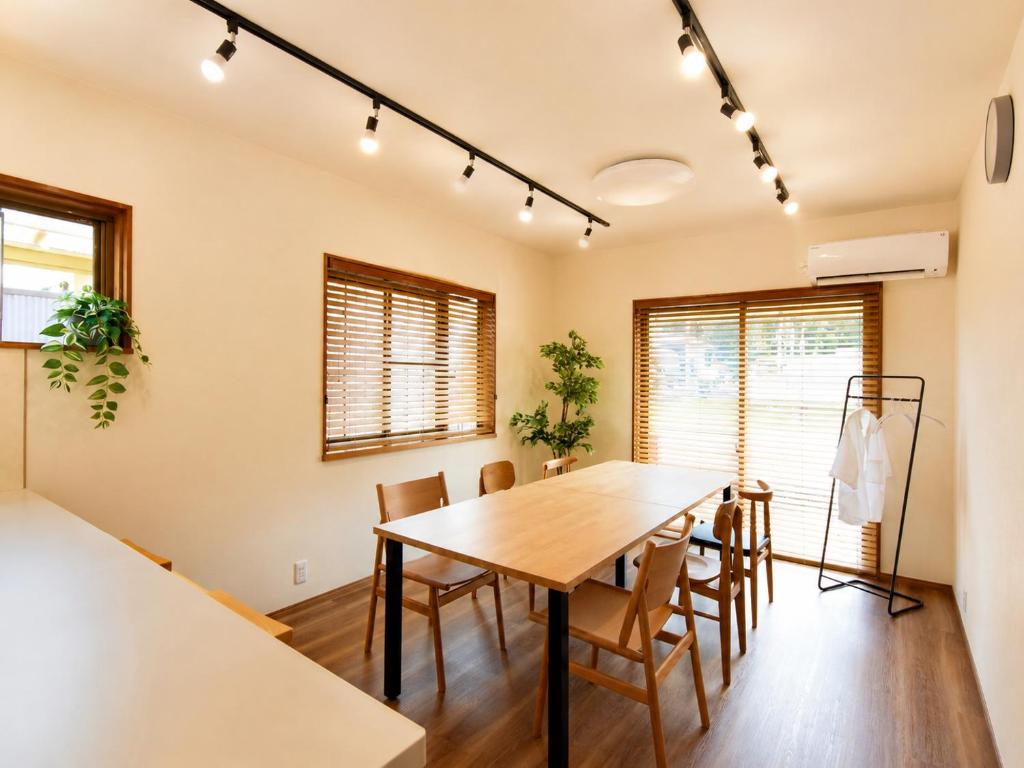 a dining room with a wooden table and chairs at にし阿波ねすと in Higashimiyoshi