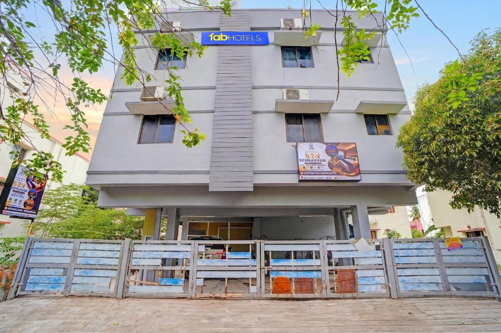 a building with a fence in front of it at FabHotel Nimalan Residency Tambaram in Chennai