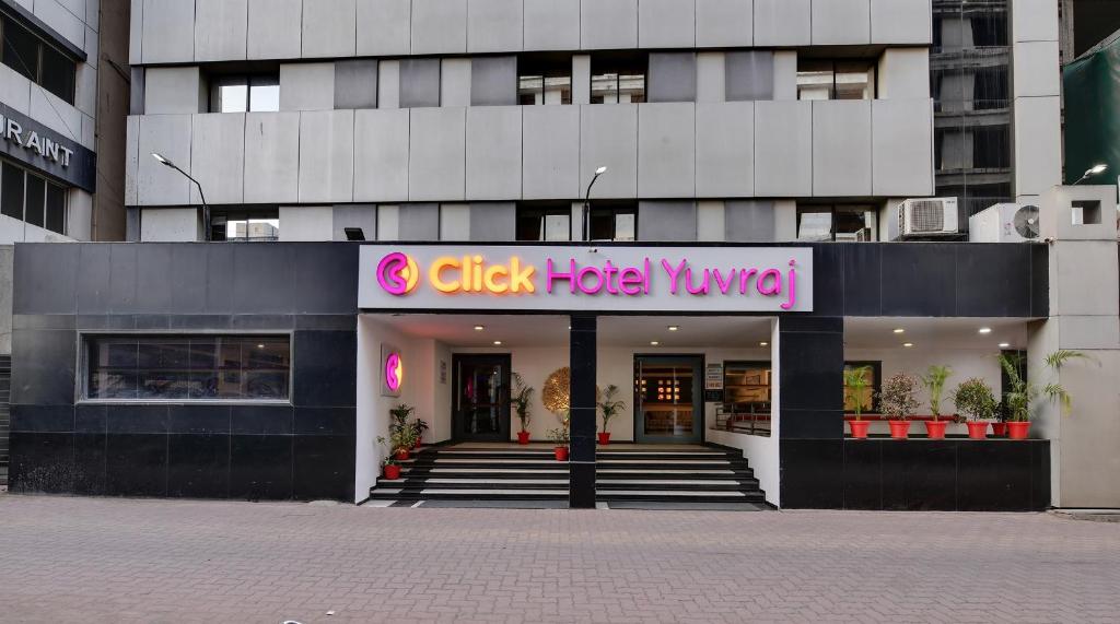 a building with a sign that reads clickeper kvind at Click Hotel Yuvraj in Surat