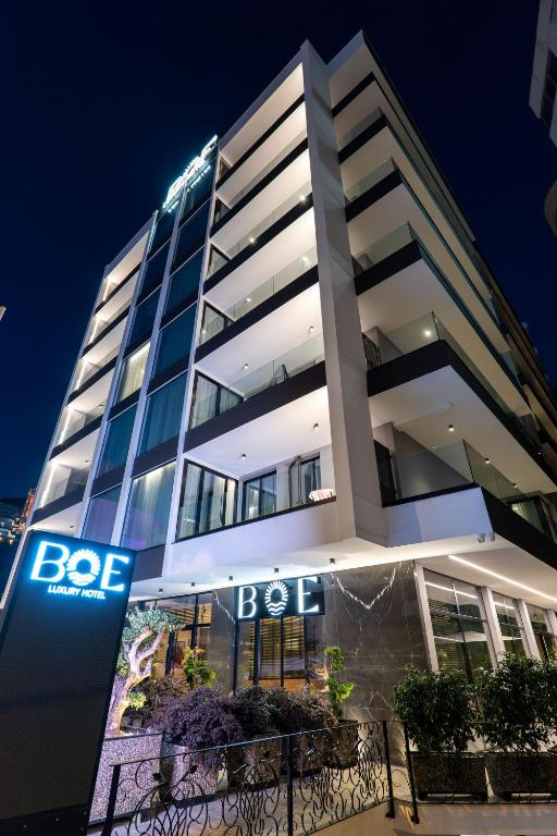 a building with a btec sign in front of it at Boe Luxury Hotel in Sarandë