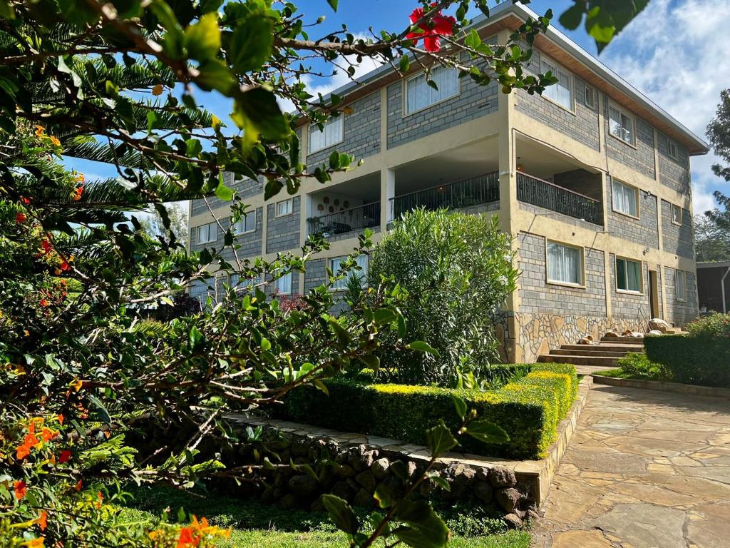 a building with a garden in front of it at Hilltop Lakeview in Munyu