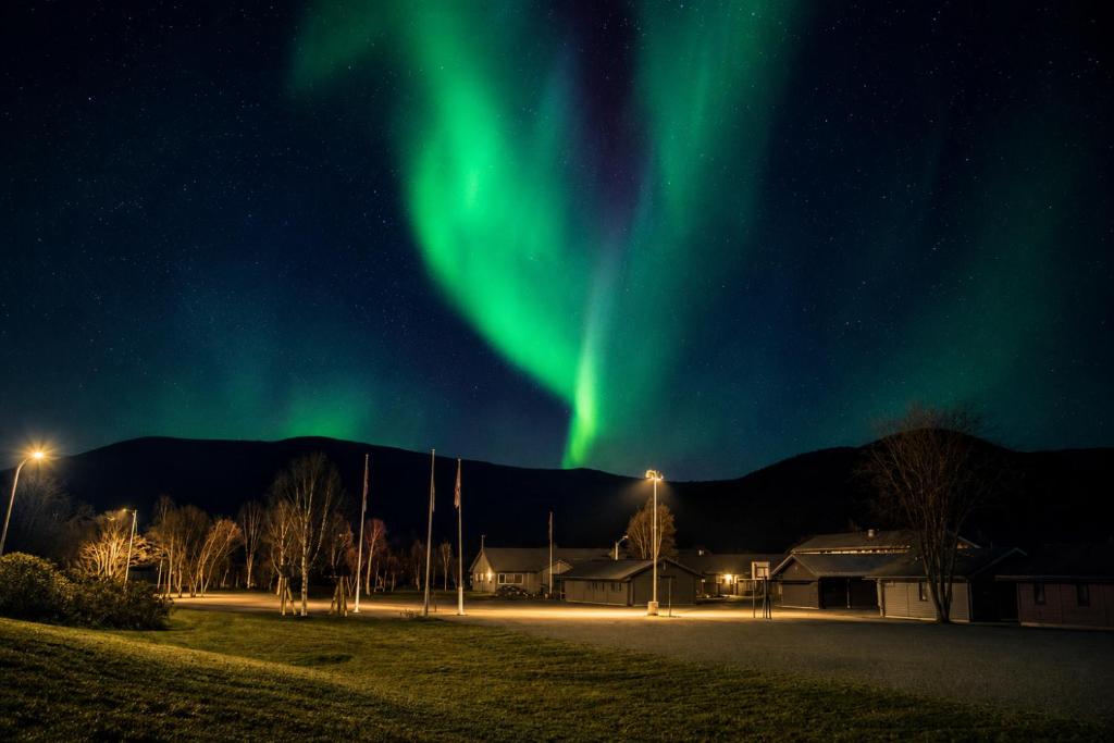 an image of the aurora dancing in the sky at Haraldvollen Red Cross Center in Bardufoss