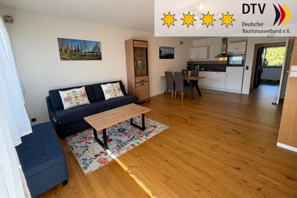 a living room with a couch and a table at Höri-Nest Wohlfühl-Appartement in Gaienhofen