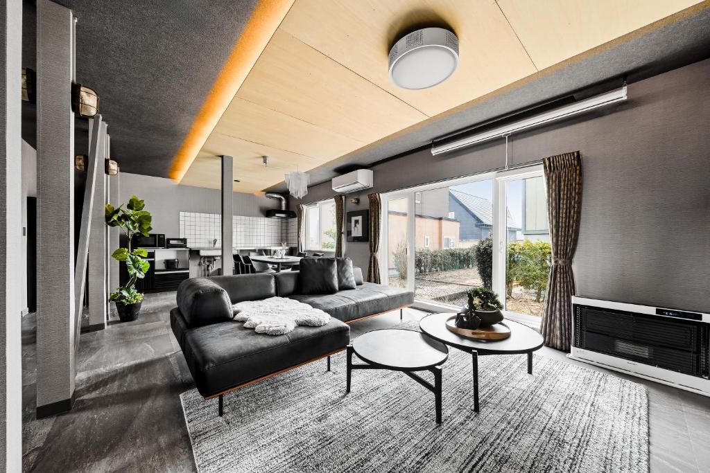a living room with a couch and a table at The Lavenridge in Nakafurano