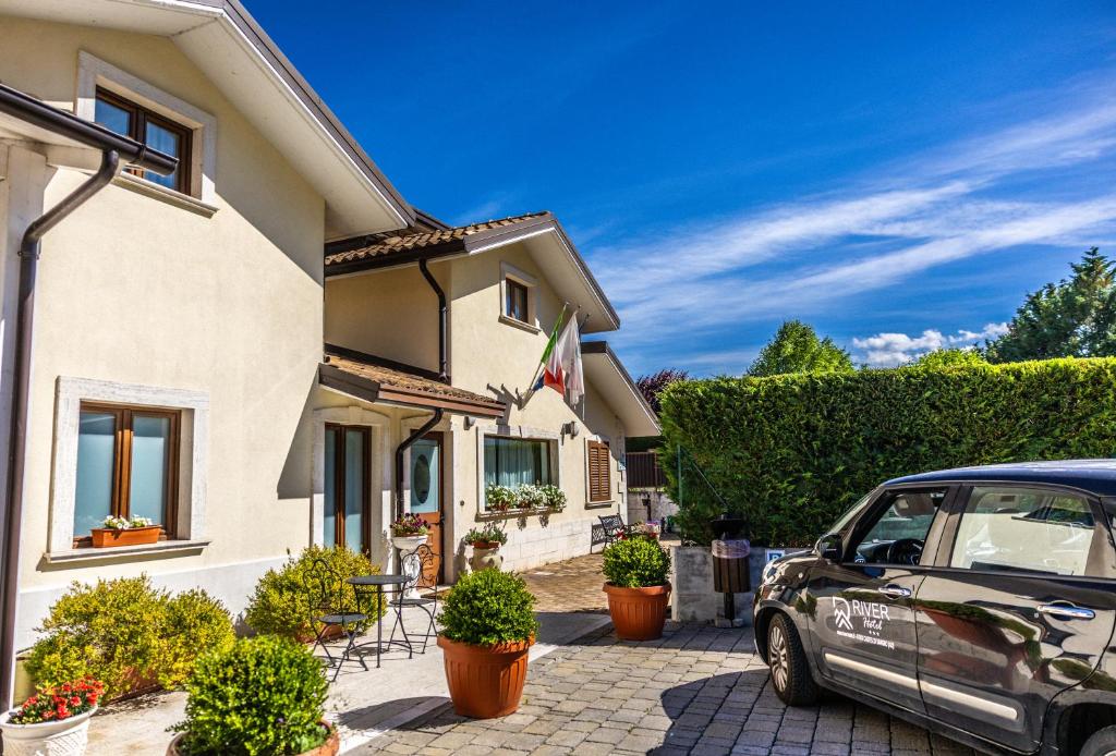 a car parked in front of a house at River Hotel in Castel di Sangro