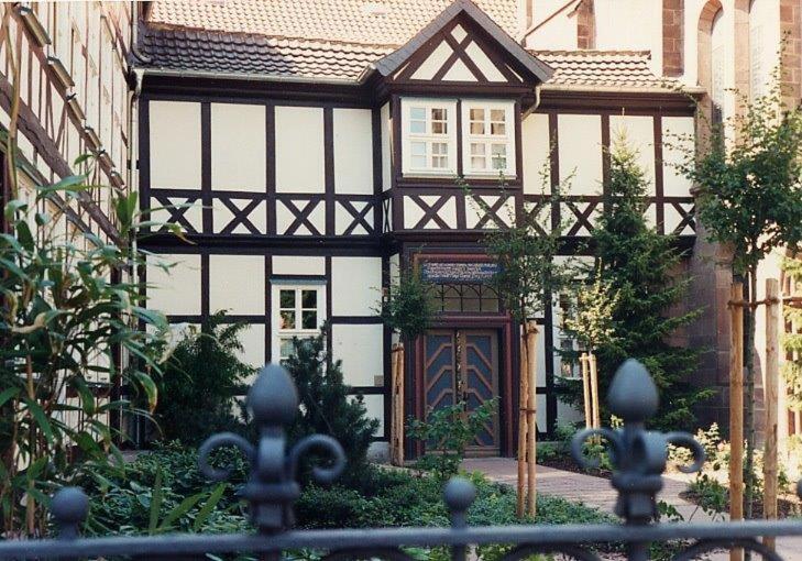 an old black and white house with a door at Ursulinenkloster in Duderstadt