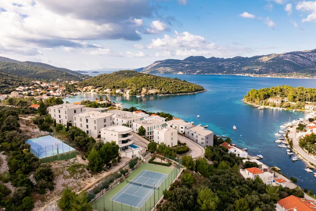 an aerial view of a resort on a lake with a tennis court at Korcula Luxury Apartments in Korčula