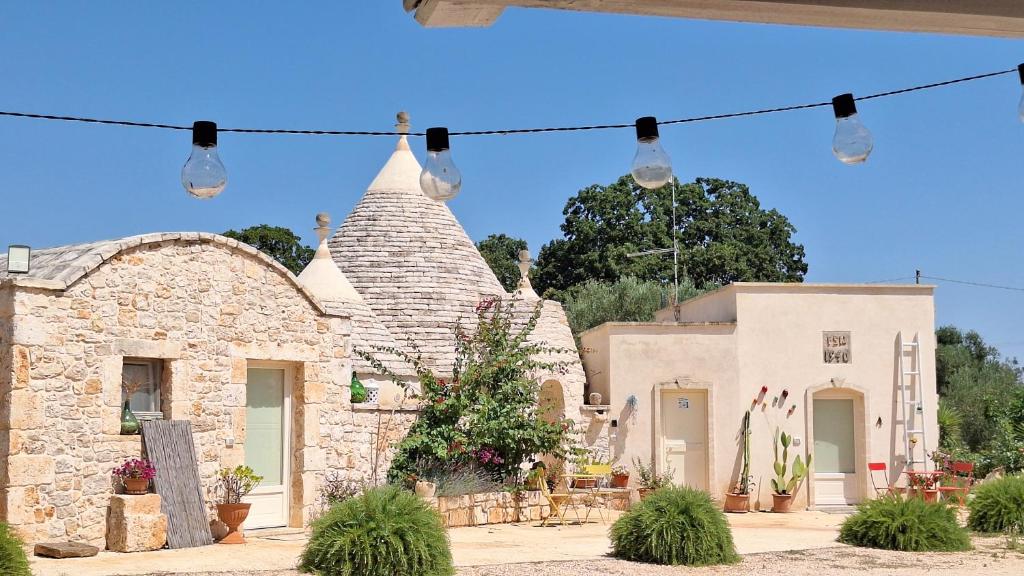 a stone building with lights in front of it at Residenza Anima Mediterranea in Francavilla Fontana