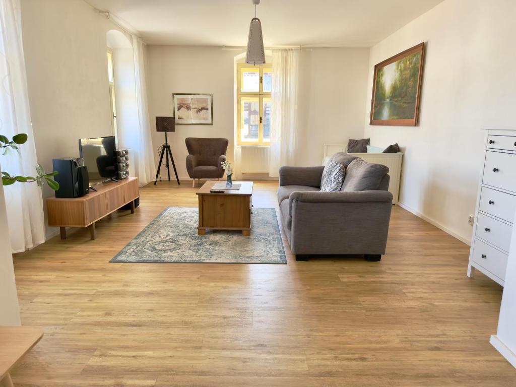 a living room with a couch and a coffee table at Apartmány u komína in Terezín