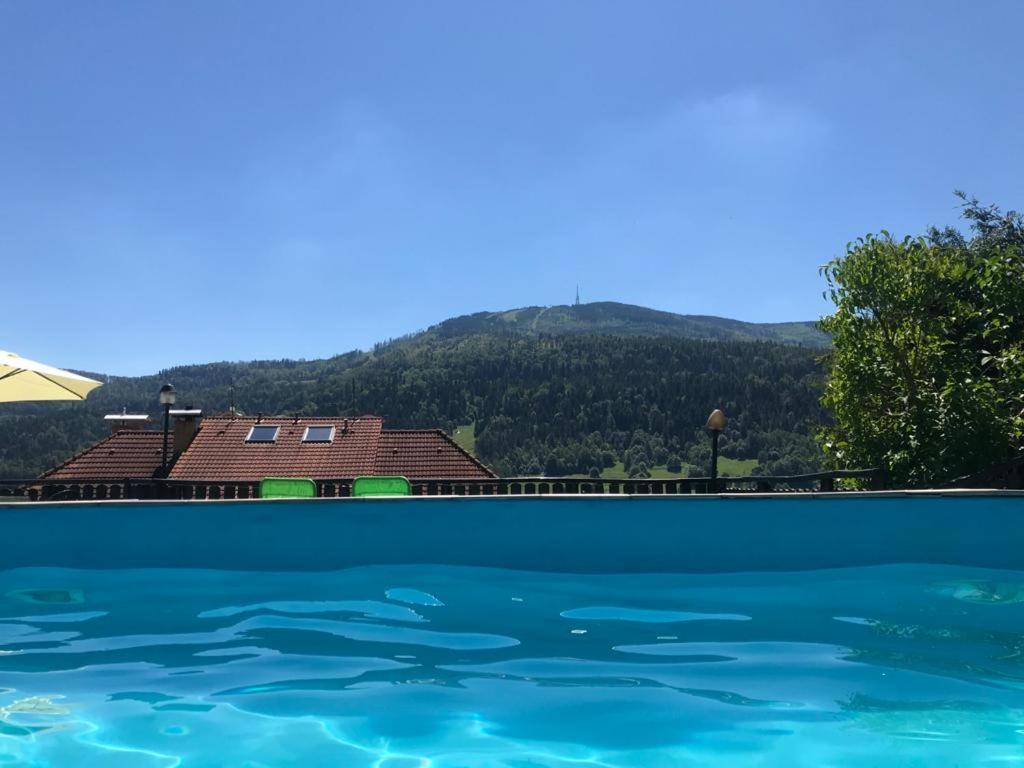 a swimming pool with a mountain in the background at EDEN Szczyrk Basen z widokiem na Skrzyczne in Szczyrk
