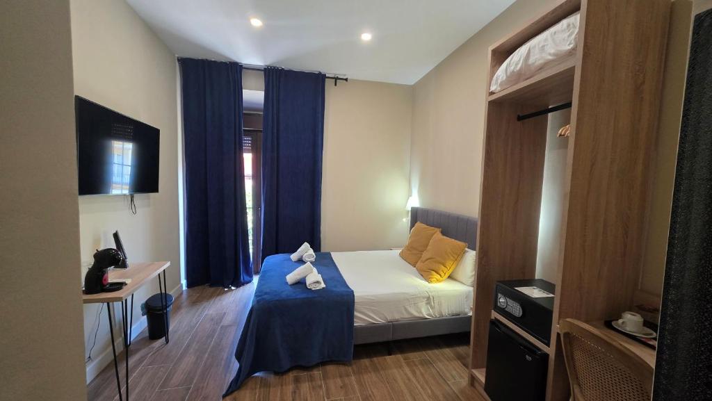 a bedroom with a bed with a teddy bear on it at Casona de San Andrés Boutique Hotel in Seville