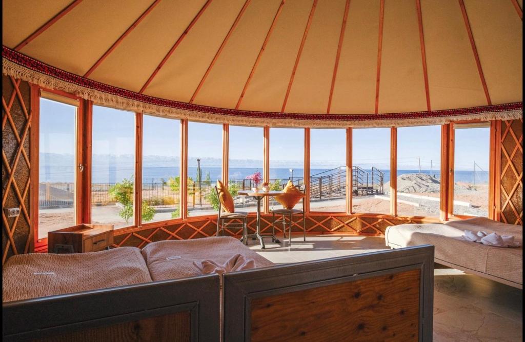 a room with a tent with a view of the ocean at Casablanca Yurts in Kaji-Say