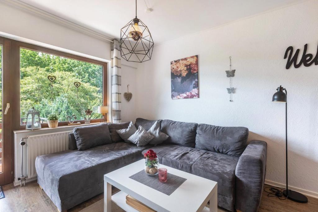 a living room with a couch and a table at Ferienwohnung Talblick in Medebach
