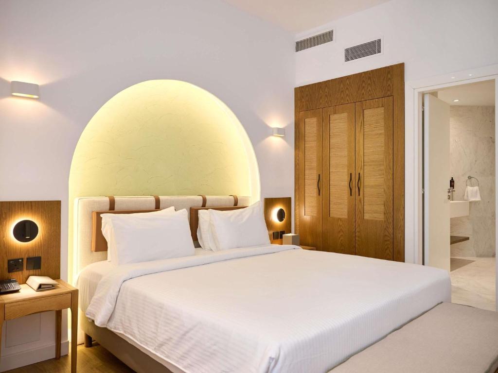 a bedroom with a large bed with a large orb above it at The Classic Hotel Nicosia - Handwritten Collection in Nicosia