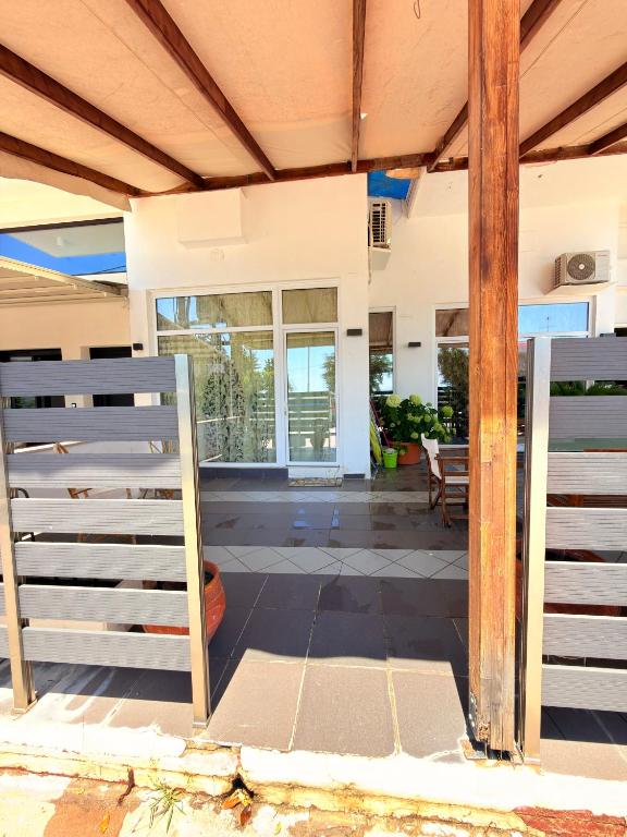an open door of a house with a porch at Premier Sea Apartment in Paleo Tsifliki