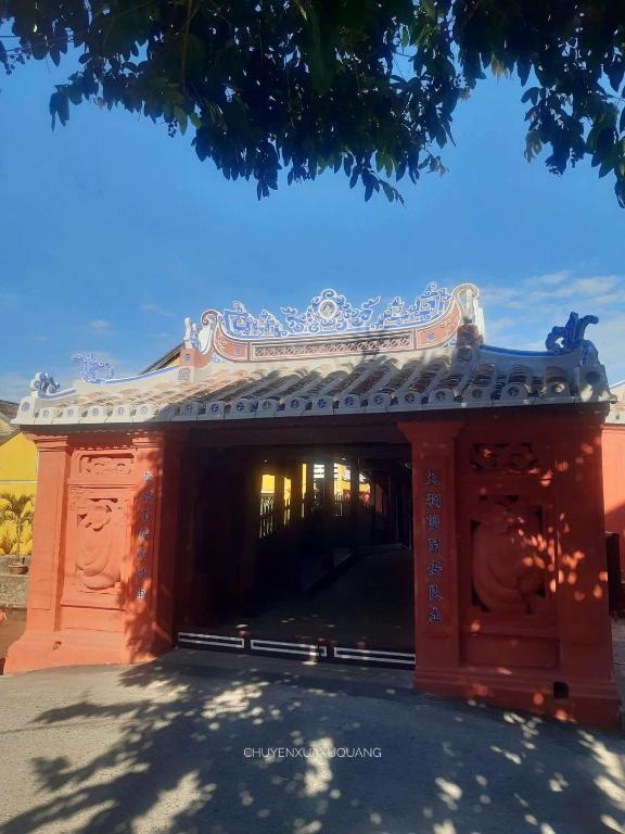 a red building with avisor on top of it at Hoi An Viet Nam in Hoi An
