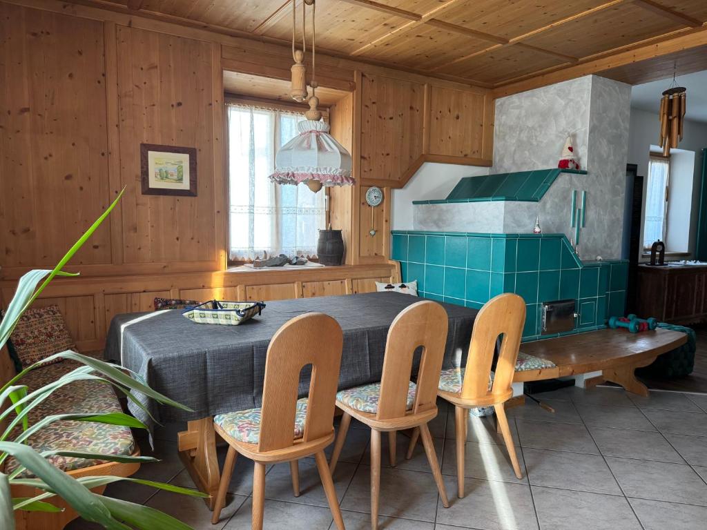 a kitchen with a table and chairs in a room at Apartments Trettel in Tesero
