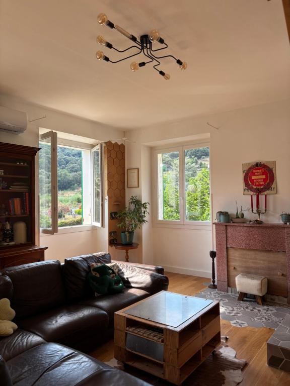 a living room with a couch and a table at Village vacations in Guarguale