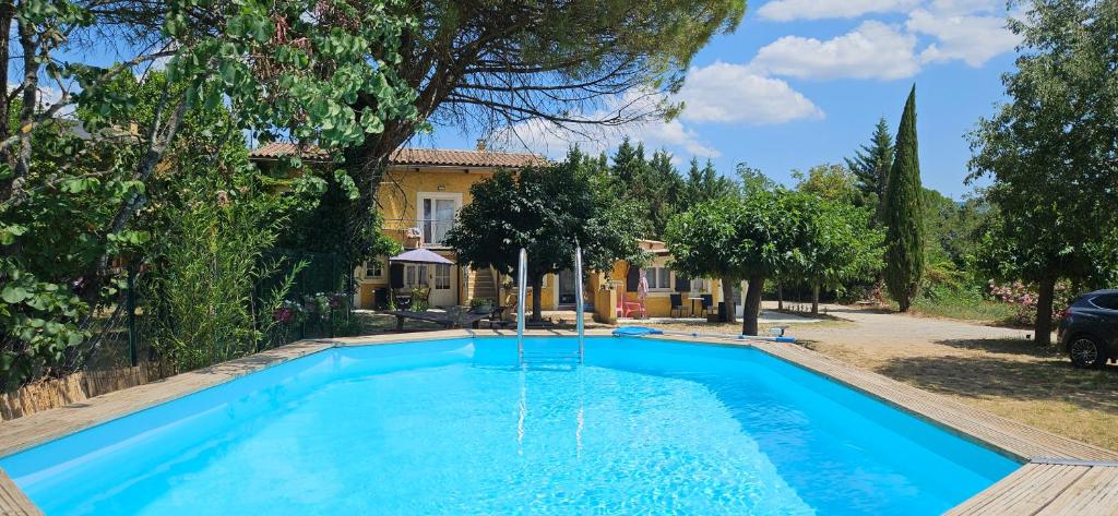 a swimming pool in front of a house at Gîte 4 - LE RAZAL in Vallon-Pont-dʼArc