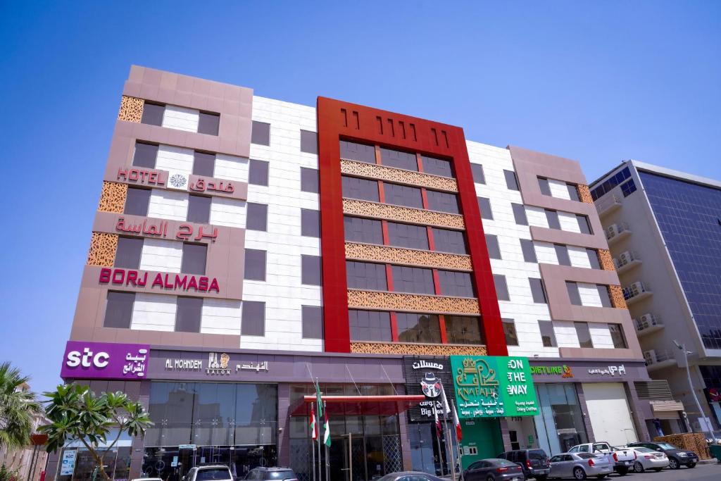 a building on a street with cars parked in front of it at Diamond Tower Hotel in Jeddah