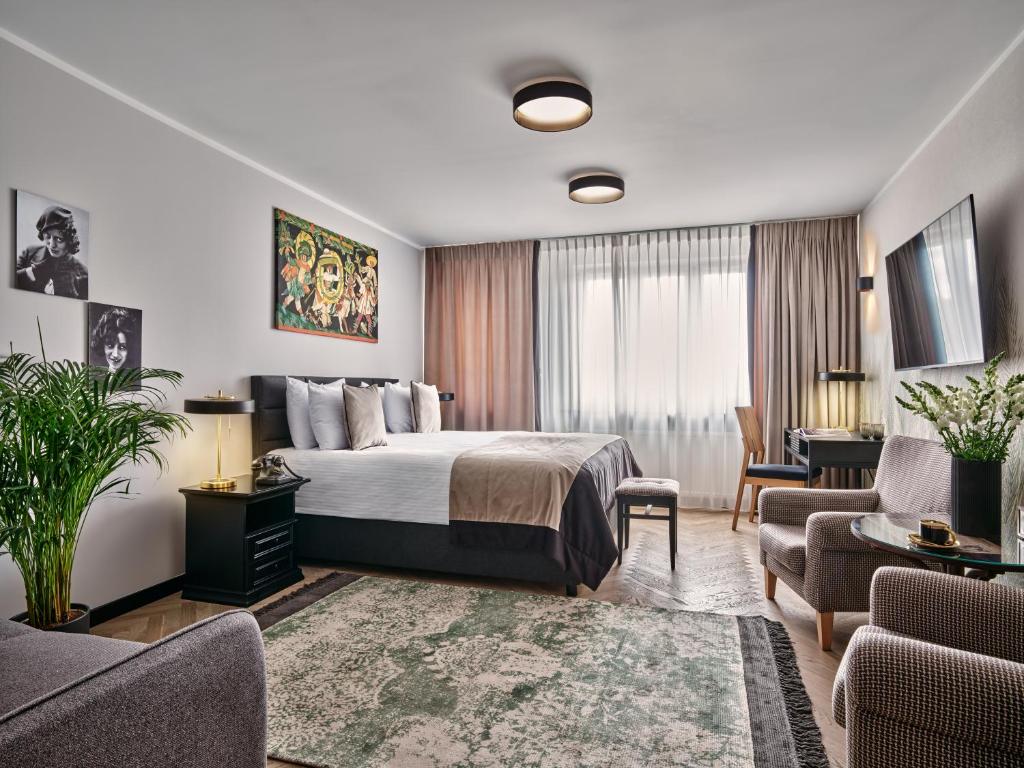 a hotel room with a bed and a living room at Dethloff Art Residence in Warsaw