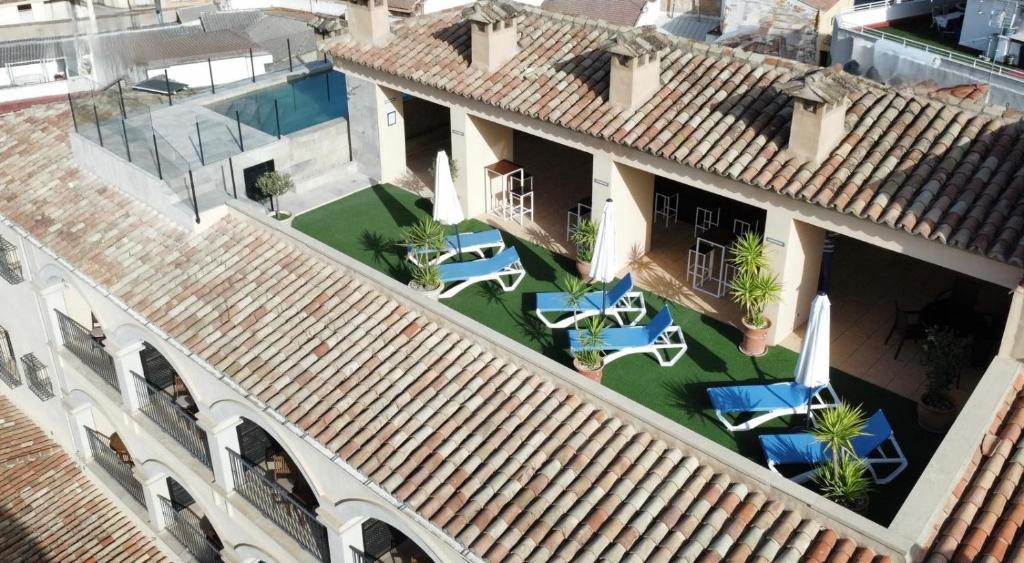 an aerial view of a building with tables and chairs at Hotel Palacio de Mengibar in Mengibar