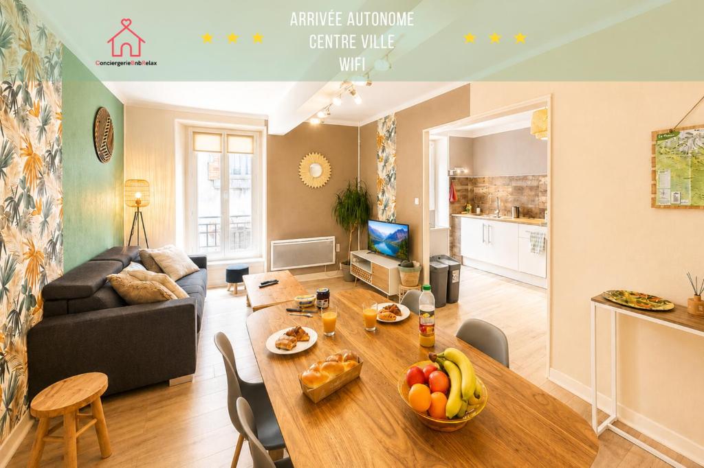a living room with a table with fruit on it at " Loutrein Lodge " Centre ville - Entrée autonome - Wifi in Saint-Girons