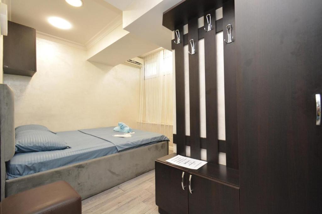 a small bedroom with a bed and a table at Old Yerevan Guesthouses in Yerevan