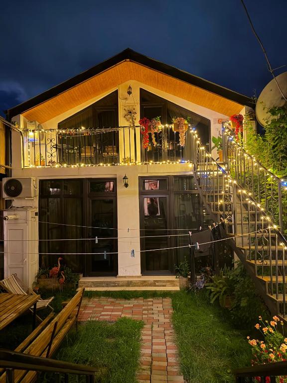 a house with a balcony with lights on it at Nitsa Guest House in Gori