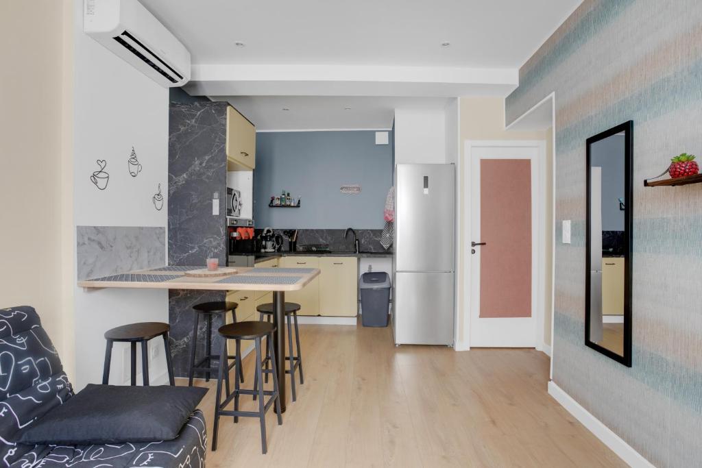 a kitchen and a living room with a table and chairs at O'soleil in Fréjus
