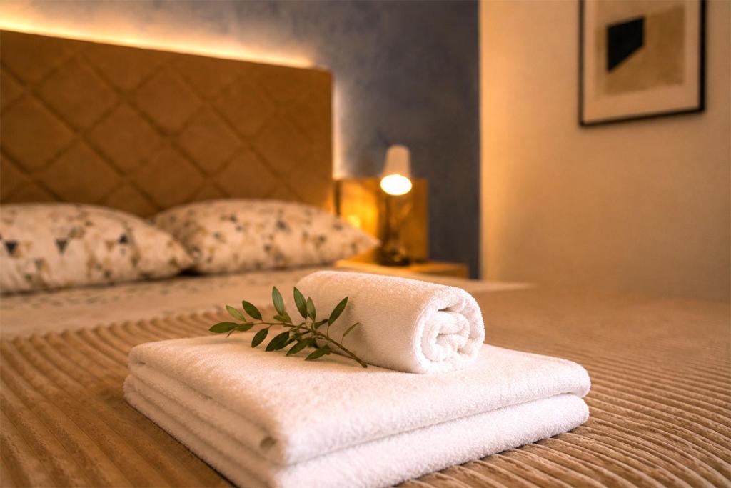 a pile of towels sitting on top of a bed at Blue Skies in Podgorica