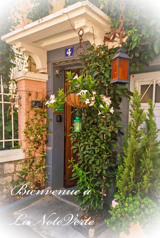 a front door of a house with a bunch of plants at La Note Verte - Parking gratuit devant l'entrée in Foix