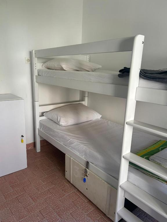 a bunk bed room with two bunk beds with a pillow at Hostel Omiš in Omiš