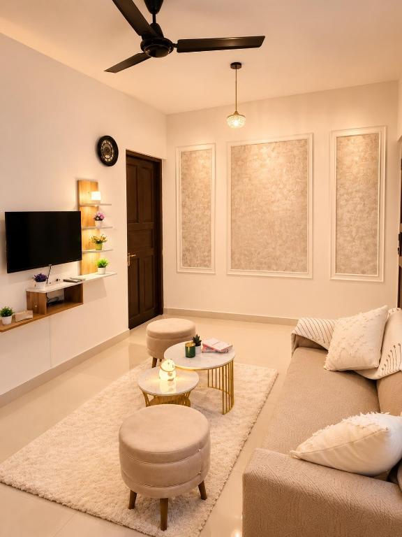 a living room with a couch and a tv at BNBees Anjuna Goa in Chapora