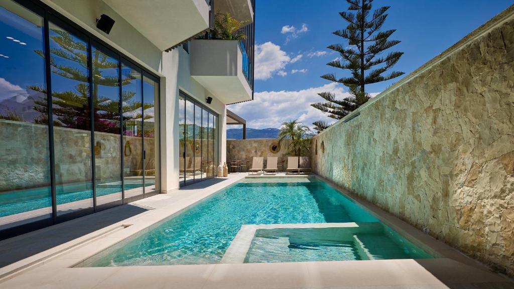 a swimming pool in the backyard of a house at Veranda Hotel by Mirage in Ksamil