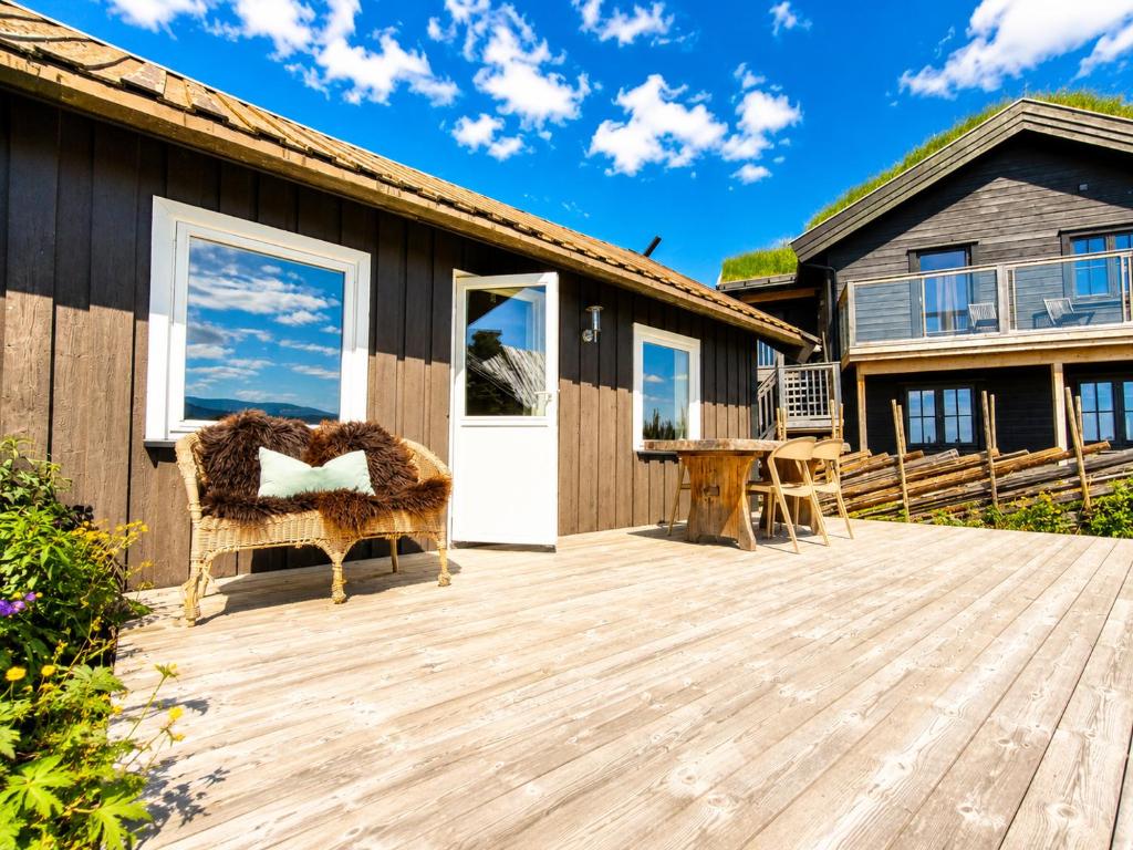 a wooden deck with a house at Charming cabin with a view in Gol