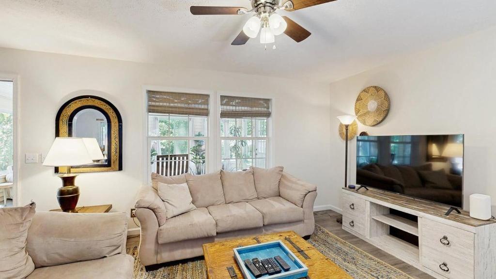 a living room with a couch and a flat screen tv at Piney Glade - 18628 Sylvan Dr in Rehoboth Beach